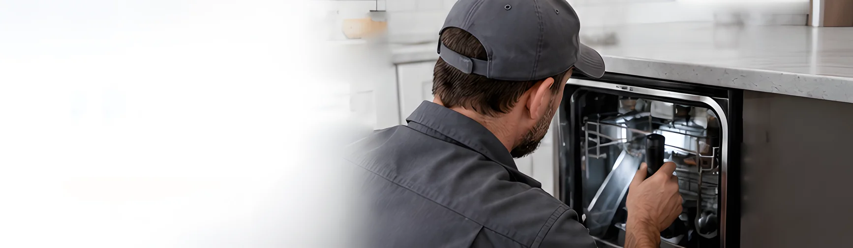 An appliance technician testing inside a dishwasher in a kitchen