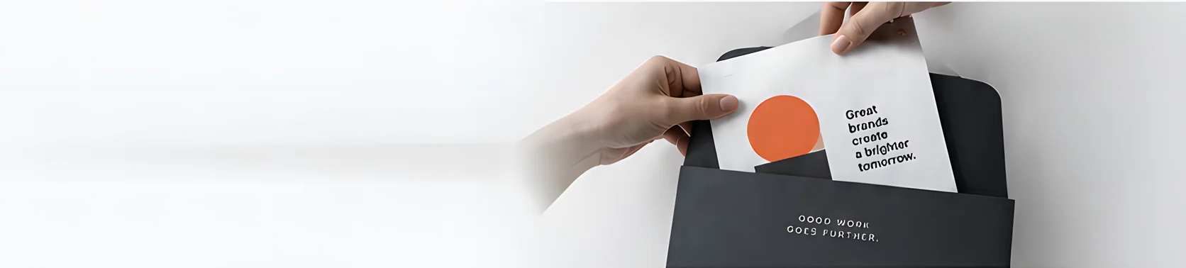 Hands sliding a printed design proof into a dark presentation folder