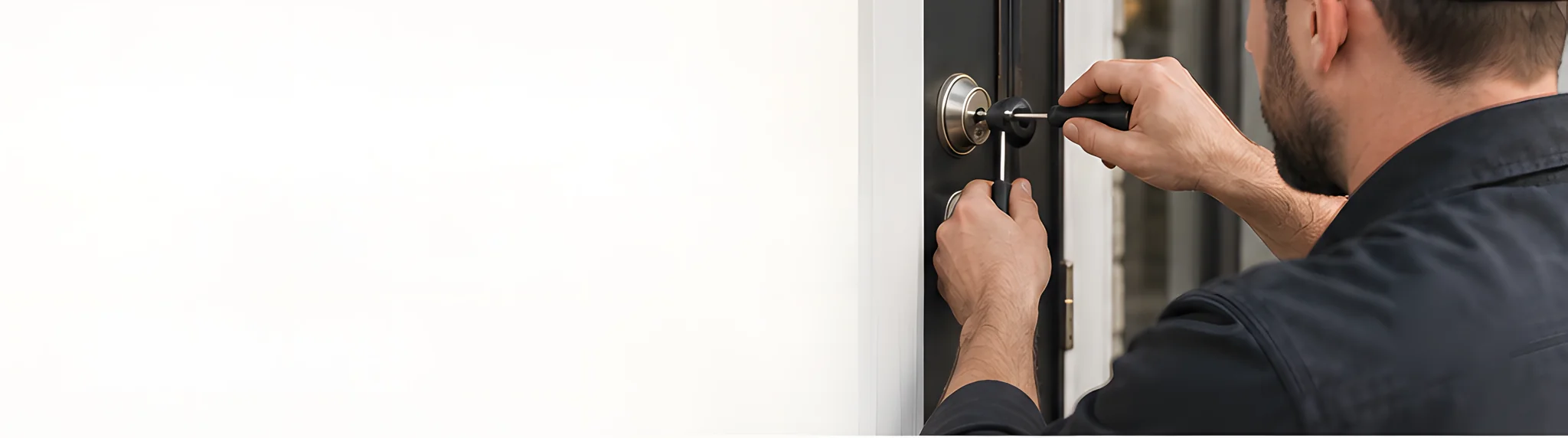 A locksmith picks the cylinder of a front door lock